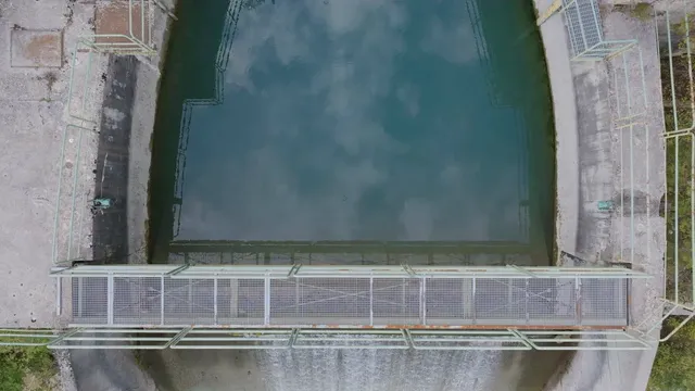 Horizontal video: Aerial view of water flowing over dam spillway 28963707. Duration: 13 seconds. Resolution: 3840x2160