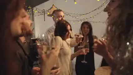 Horizontal video: People in a party raising their glasses for a toss while confetti are falling 3188991. Duration: 9 seconds. Resolution: 1920x1080