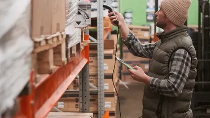 Horizontal video: Man scanning the codes of the stocks in the warehouse 4292902. Duration: 18 seconds. Resolution: 3840x2160