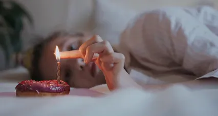 Horizontal video: A woman laying in bed with a lit candle 4690718. Duration: 37 seconds. Resolution: 4096x2160