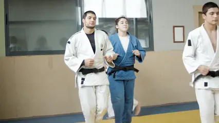 Horizontal video: Athletes warming up in dojo 6765218. Duration: 18 seconds. Resolution: 2688x1512