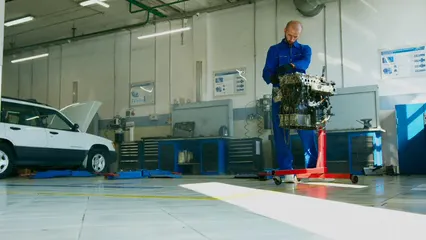 Horizontal video: Low angle shot of a mechanic working on an engine 8986893. Duration: 12 seconds. Resolution: 3840x2160