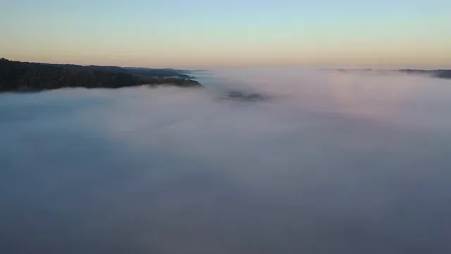 Horizontal video: Aerial drone footage of foggy landscape at sunrise 28989707. Duration: 68 seconds. Resolution: 3840x2160