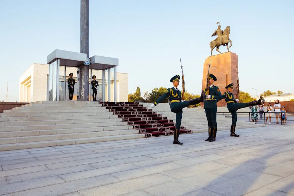 A group of soldiers in uniform are standing in front of a monument