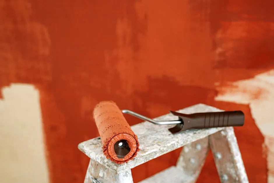 Paint Roller With Brown Paint On A Stepladder