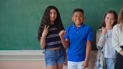 Horizontal video: A teacher and her students smiling while posing 8500482. Duration: 15 seconds. Resolution: 1920x1080