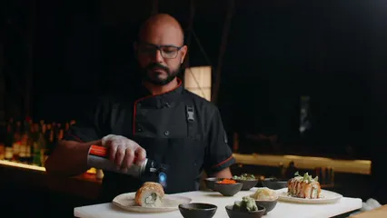 Horizontal video: A chef using a blow torch on a sushi 8902152. Duration: 12 seconds. Resolution: 1920x1080