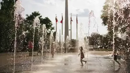 Horizontal video: Slow motion footage of children and adults playing in the water fountains 2836305. Duration: 25 seconds. Resolution: 3840x2160