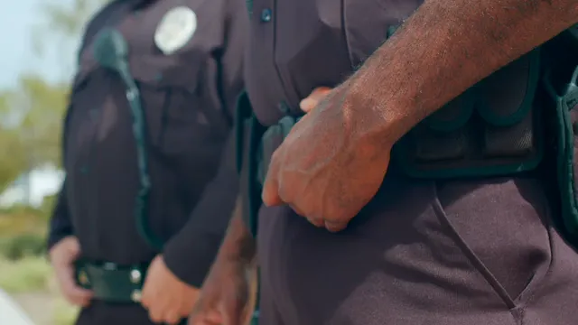 Horizontal video: Close up of a police officer holding his belt 7713973. Duration: 16 seconds. Resolution: 3840x2160