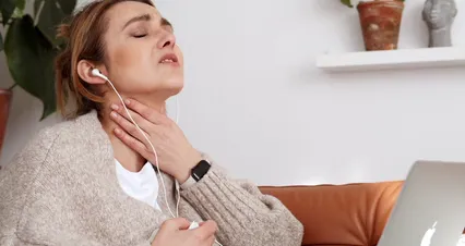 Horizontal video: Woman touching her neck while talking on a video call 7195996. Duration: 8 seconds. Resolution: 4096x2160