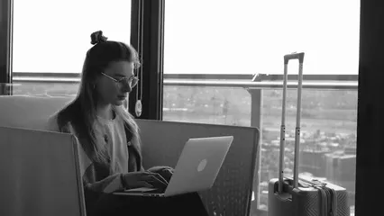 Horizontal video: A woman working using a laptop while in the airport 12703253. Duration: 10 seconds. Resolution: 3840x2160