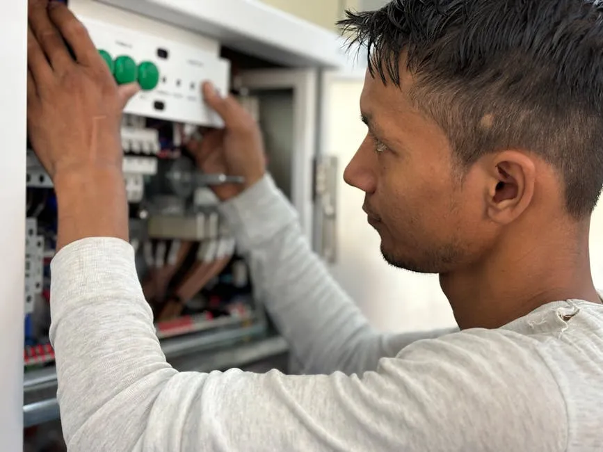 A man is working on an electrical panel