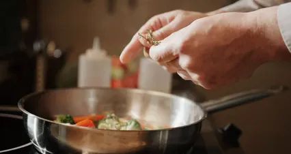 Horizontal video: A person stirring food in a pan 4252289. Duration: 28 seconds. Resolution: 4096x2160