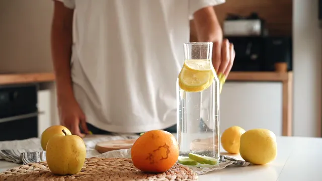 Horizontal video: A person putting a sliced lemon on a glass of water 9001889. Duration: 8 seconds. Resolution: 1920x1080