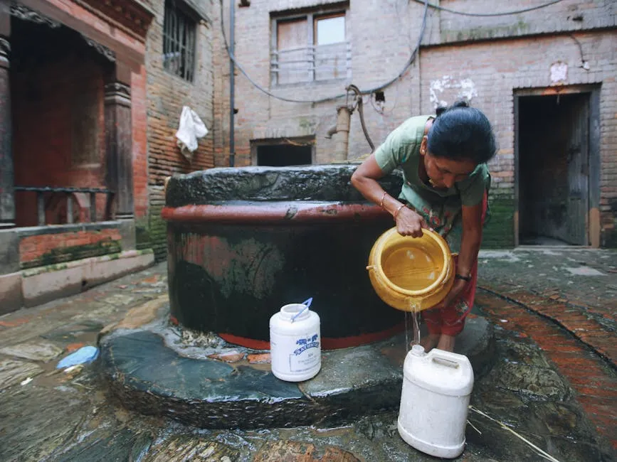 A Woman Pouring Water into a Bottle