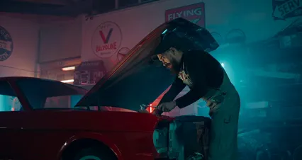 Horizontal video: A man is working on a car in a garage 4488706. Duration: 48 seconds. Resolution: 4096x2160