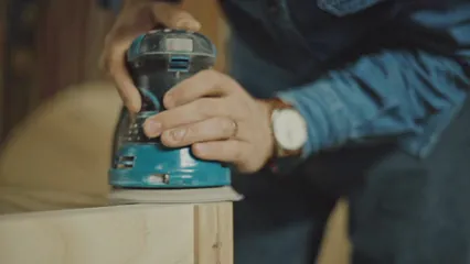 Horizontal video: A person using a grinding machine to smoothen the wooden surface 4957770. Duration: 9 seconds. Resolution: 1920x1080