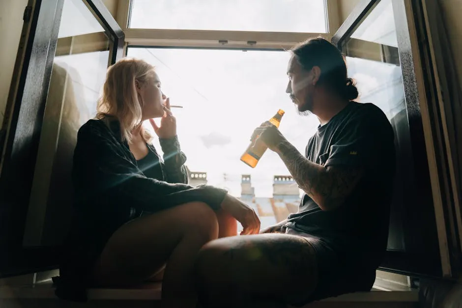 A Couple Smoking and Drinking by a Window