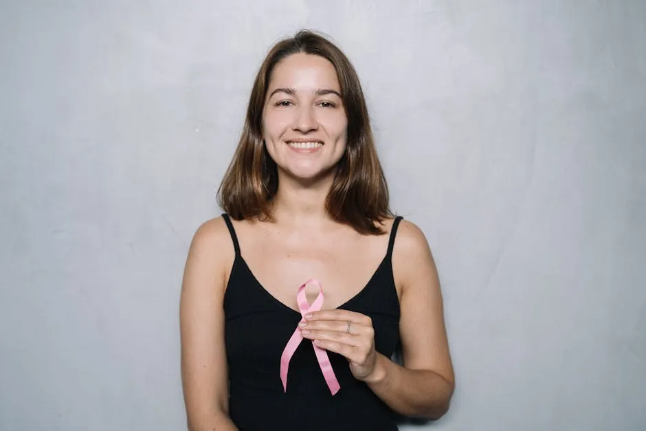 Woman in Black Spaghetti Strap Top Holding Pink Ribbon