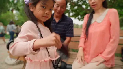 Horizontal video: Little girl shaking a polaroid film 8298352. Duration: 10 seconds. Resolution: 1920x1080
