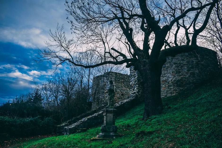 Leafless Tree Beside Gray Concrete Statue