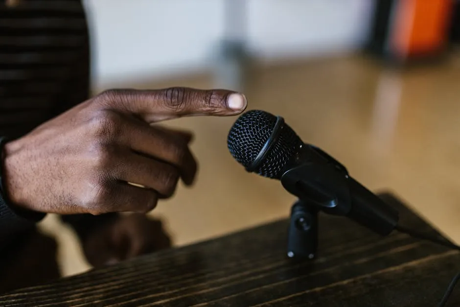 A Person Touching a Microphone