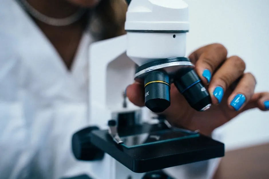 Close-Up Shot of a Person Using a Microscope