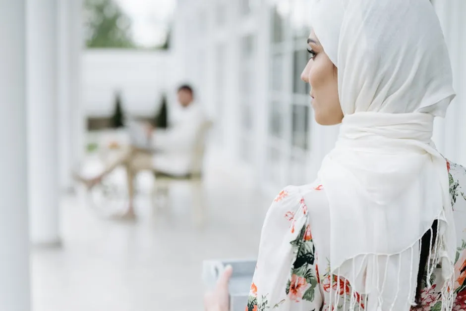 Woman in Floral Dress with White Headscarf Holding a Serving Tray