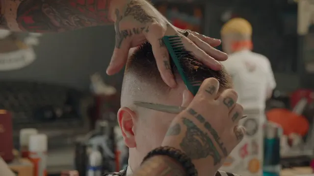Horizontal video: A barber making a haircut to a boy 9737935. Duration: 13 seconds. Resolution: 3840x2160