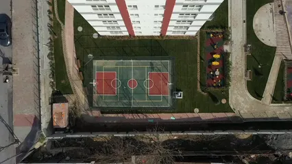 Horizontal video: An aerial view of a basketball court and a tennis court 19375618. Duration: 9 seconds. Resolution: 1920x1080