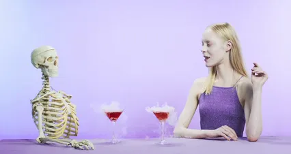 Horizontal video: Halloween theme video of a woman drinking with skeleton 5547212. Duration: 12 seconds. Resolution: 4096x2160