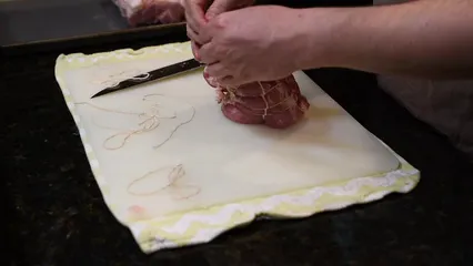 Horizontal video: Person tying a meat 5755913. Duration: 55 seconds. Resolution: 3840x2160