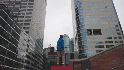 Horizontal video: Young person looking at skyscrapers 6020103. Duration: 15 seconds. Resolution: 1920x1080
