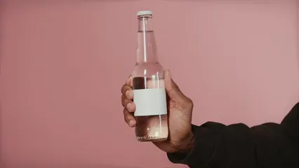 Horizontal video: A man holding a glass bottle filled with water 6612151. Duration: 12 seconds. Resolution: 3840x2160