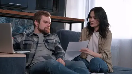 Horizontal video: A couple discussing their bills while using laptop 6962697. Duration: 22 seconds. Resolution: 1920x1080