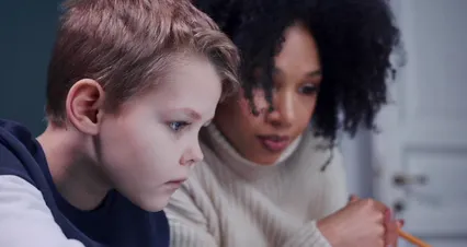 Horizontal video: A woman tutoring a boy 6986426. Duration: 17 seconds. Resolution: 4096x2160