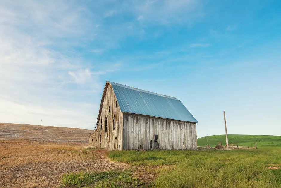 Photo of Beige and Gray Wooden Barn House on Green Grass