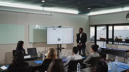 Horizontal video: A man presenting in front of people 7647785. Duration: 8 seconds. Resolution: 1920x1080