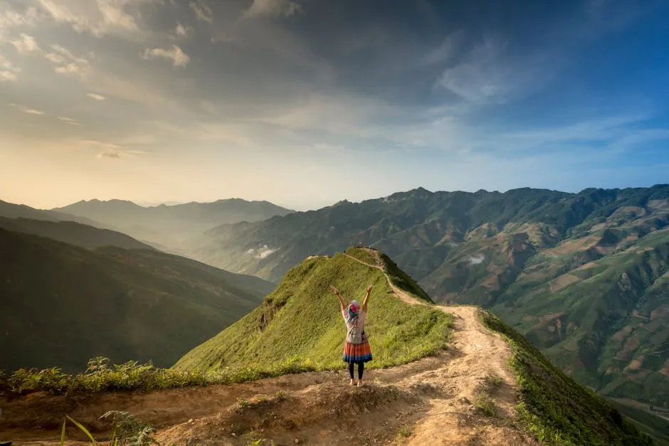 Photo of Woman Standing On Top Of Mountain