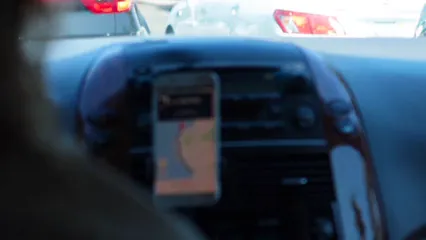 Horizontal video: Person driving a vehicle using google maps on a smartphone mounted on the dashboard 3006846. Duration: 11 seconds. Resolution: 1920x1080