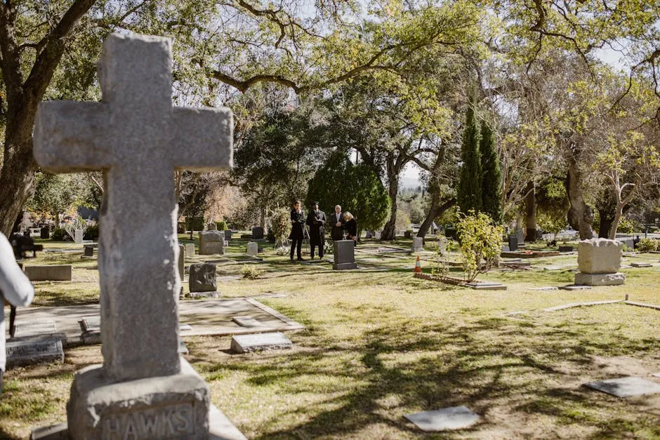 
People Grieving in a Cemetery