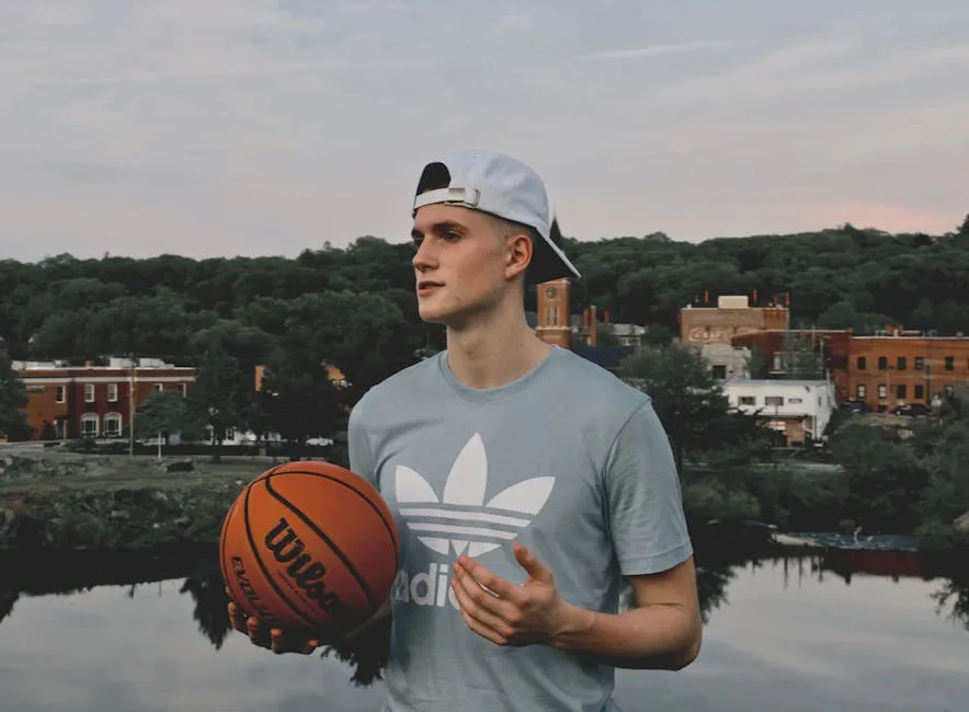 Man Wearing Gray Crew Neck Shirt Holding Basketball