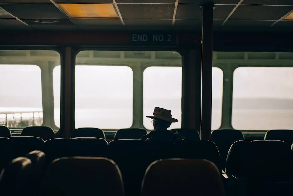 Silhouette of Man Sitting on Ferry 