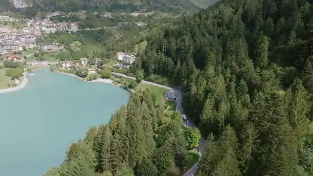 Horizontal video: Scenic aerial view of alpine lake and village 28963687. Duration: 43 seconds. Resolution: 3840x2160