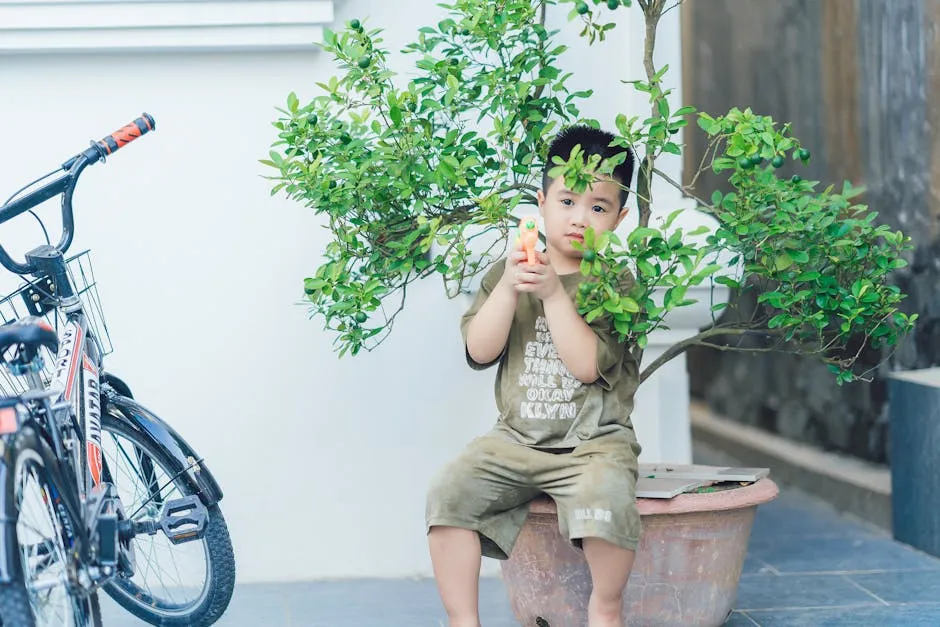 Young Boy Playing with Toy Gun Next to Bicycle