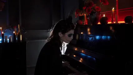 Horizontal video: A woman with a creepy makeup playing a piano 7707793. Duration: 19 seconds. Resolution: 1920x1080