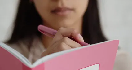 Horizontal video: Girl writing on her notebook 7976449. Duration: 19 seconds. Resolution: 4096x2160