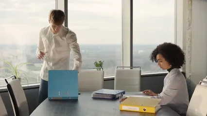 Horizontal video: A man and woman drinking water while looking at the files 8298344. Duration: 28 seconds. Resolution: 1920x1080