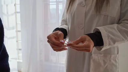 Horizontal video: A woman showing an acupuncture needle 8313313. Duration: 10 seconds. Resolution: 1920x1080