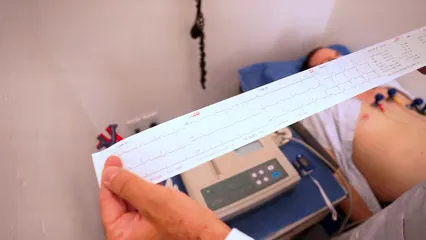 Horizontal video: Doctor holding a cardiogram result 8460070. Duration: 12 seconds. Resolution: 1920x1080